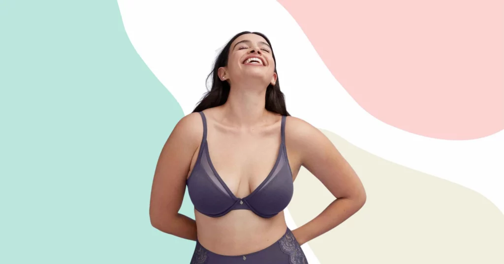 woman looking up and smiling, wearing a gray thirdlove bra