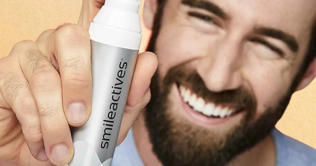 man smiling, face out of focus, holding up Smileactives whitening gel bottle