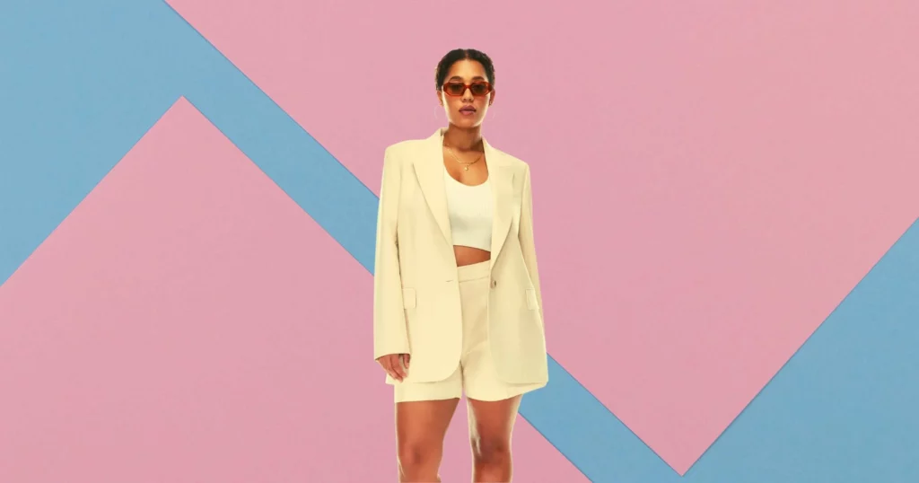 woman wearing sunglasses, wearing 2 piece cream-colored jacket and shorts from Aritzia