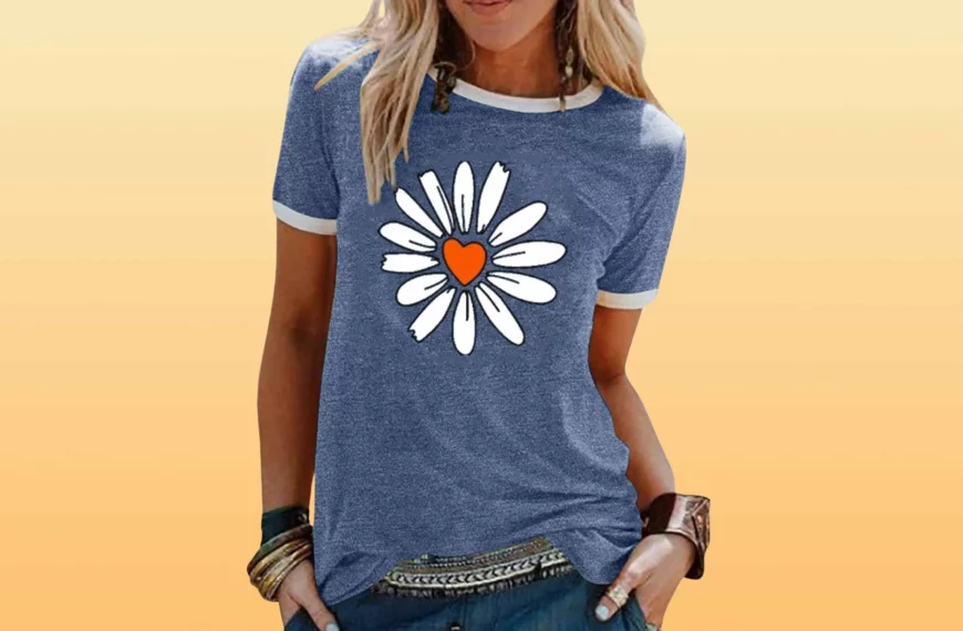 body shot of woman wearing blue shirt with sunflower and heart graphic by Lilicloth