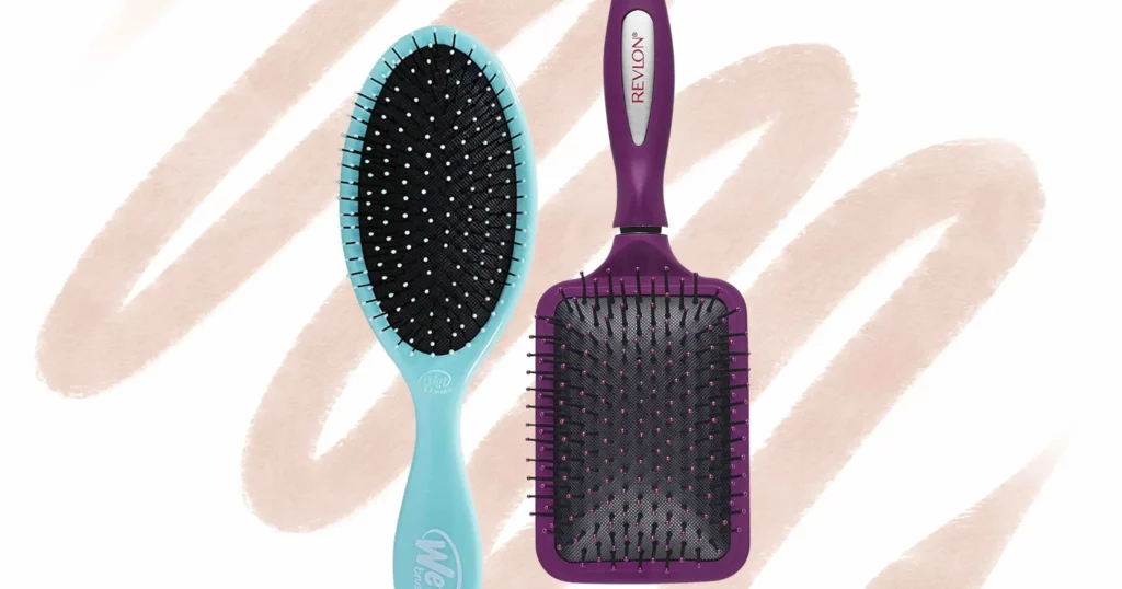 a blue wet brush next to an upside down purple paddle brush