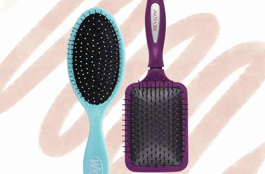 a blue wet brush next to an upside down purple paddle brush