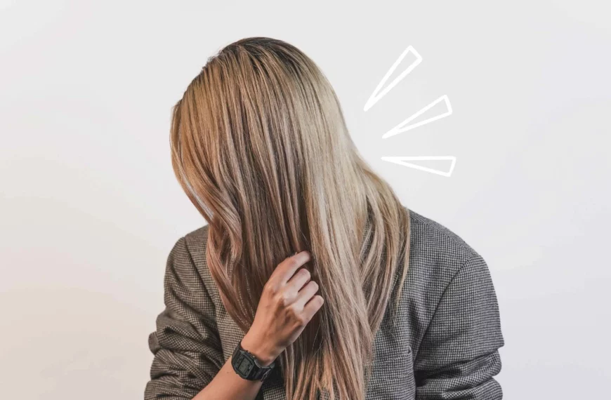 side view of woman with long blonde straight hair, touching it with her hand