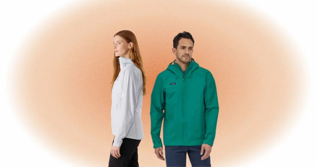 woman turned to side wearing white jacket and black pants from Patagonia, man looking off camera wearing teal Arcteryx jacket and gray pants