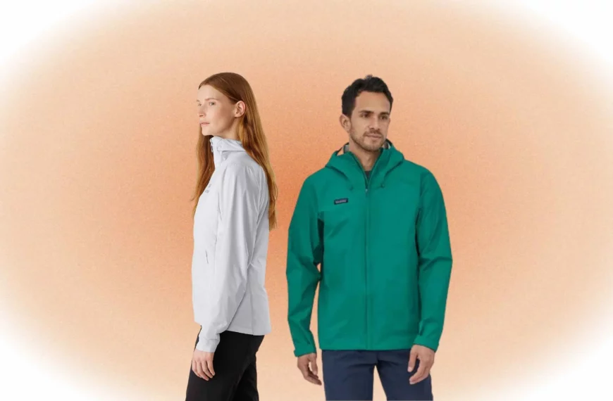woman turned to side wearing white jacket and black pants from Patagonia, man looking off camera wearing teal Arcteryx jacket and gray pants