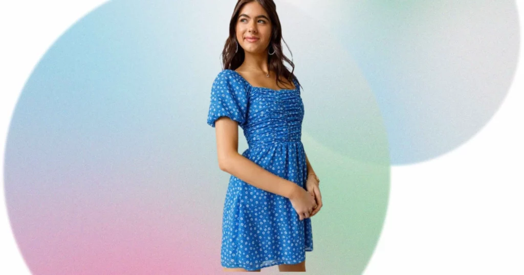 woman looking off camera wearing blue and white floral dress from Francesca's