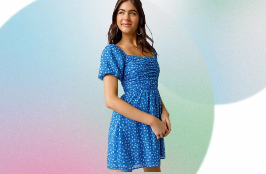 woman looking off camera wearing blue and white floral dress from Francesca's