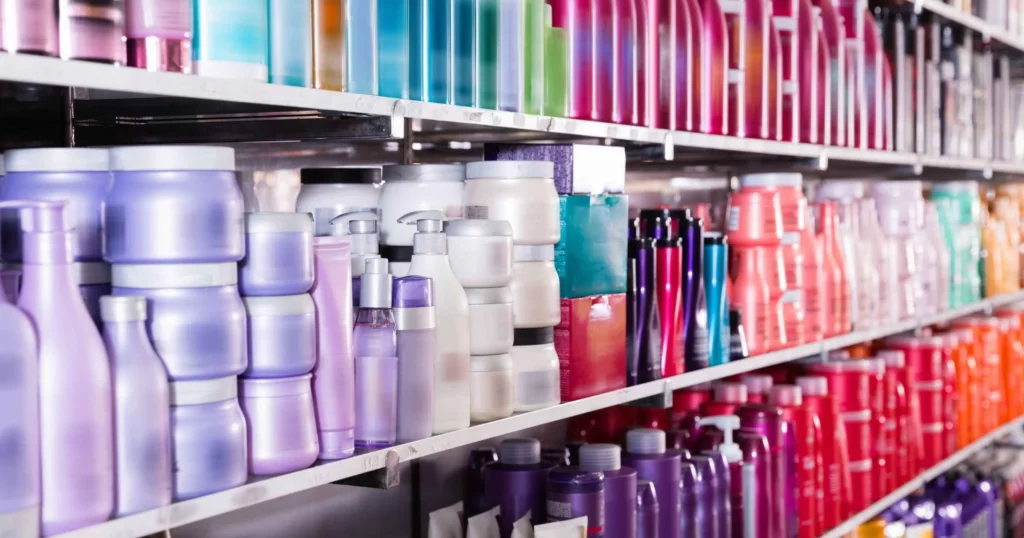 rows of shelves with different colored shampoos and other hair care products