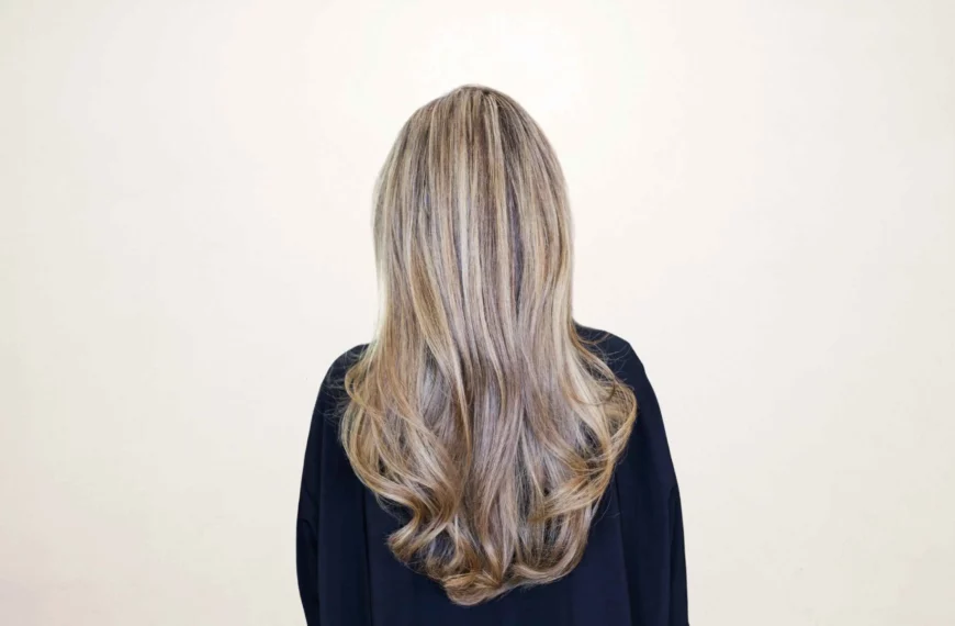 back of woman's head with long blonde hair and highlights