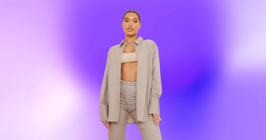 woman looking at camera, wearing beige two piece set from Pretty Little Thing; purple background
