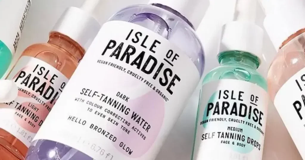 closeup of Isle of Paradise self-tanners in orange, purple, green, and pink
