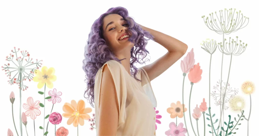 woman smiling, looking at camera with hand on head, she has purple hair from aura hair care products