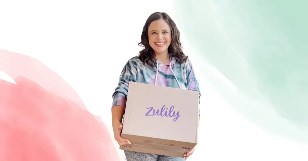 woman looking at camera, smiling, holding a box that says Zulily
