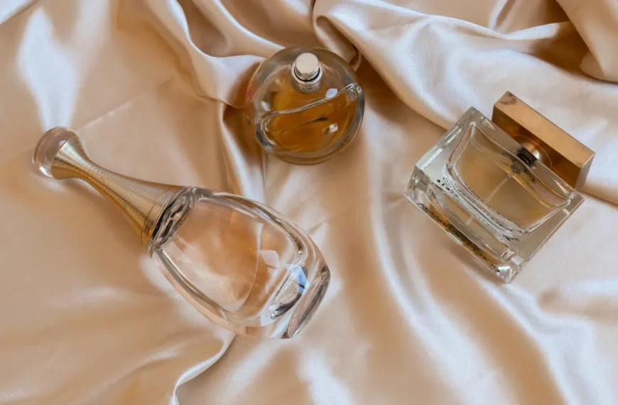 Light colored bottle of perfume and cologne on biege sheet