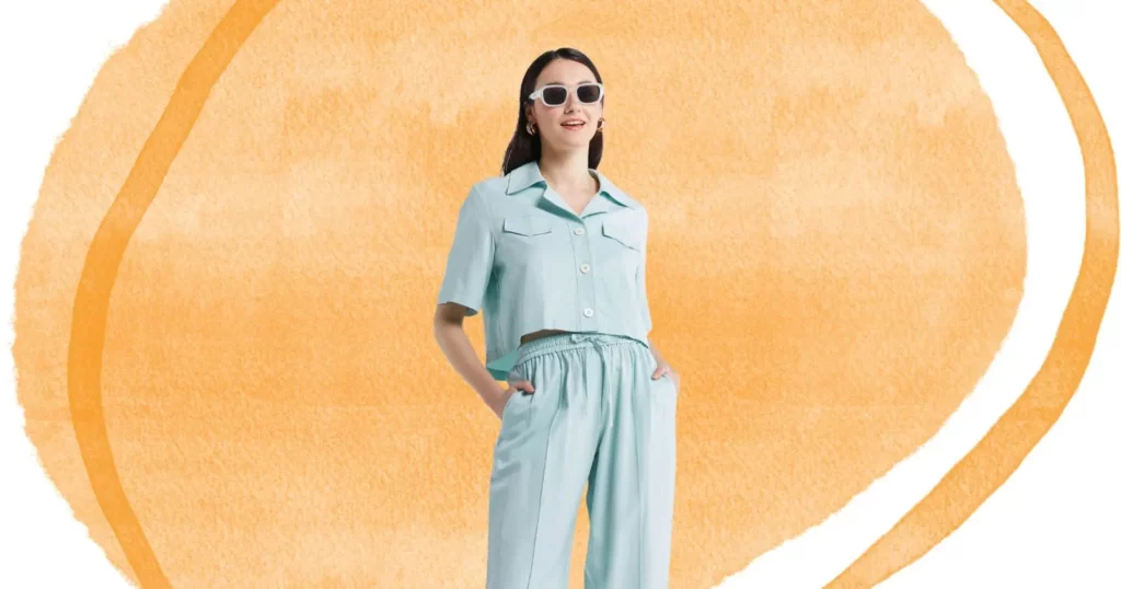 woman looking off camera, hand in her pockets, wearing sunglasses and blue outfit from Lattelier