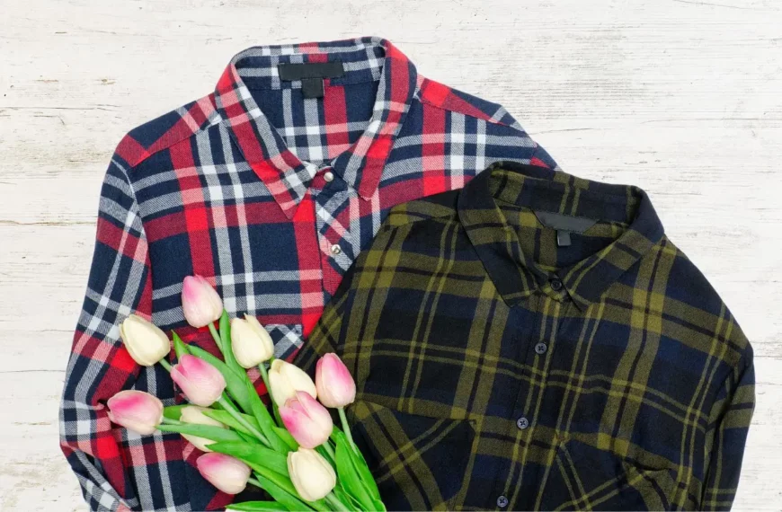 two flannel shirts with plaid patterns: one red, blue, and white, the other yellow and black. There are flowers on top of the shirts