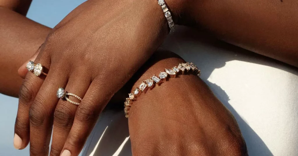 closeup of person's hands wearing diamond rings and bracelets from Vrai
