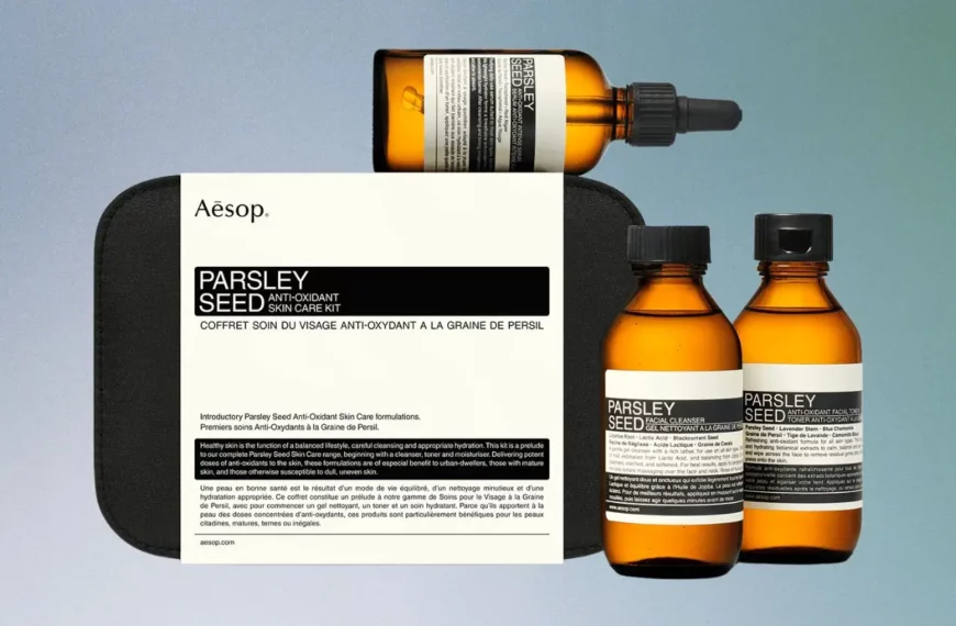 assortment of Aesop skincare products in orange bottles and black box
