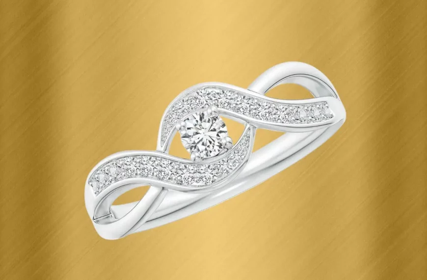 Angara diamond engagement ring against gold background