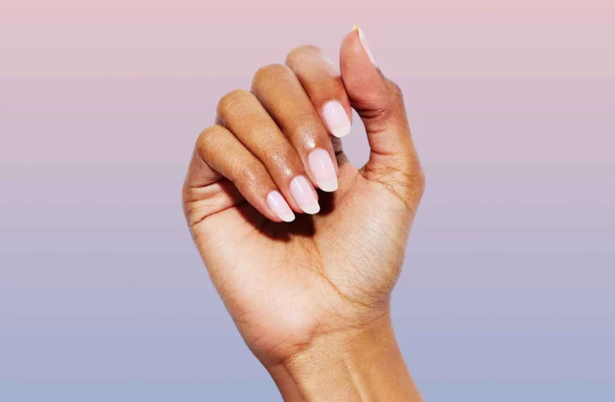 close up of woman's hand with fingernails painted a sheer pink color from Static Nails
