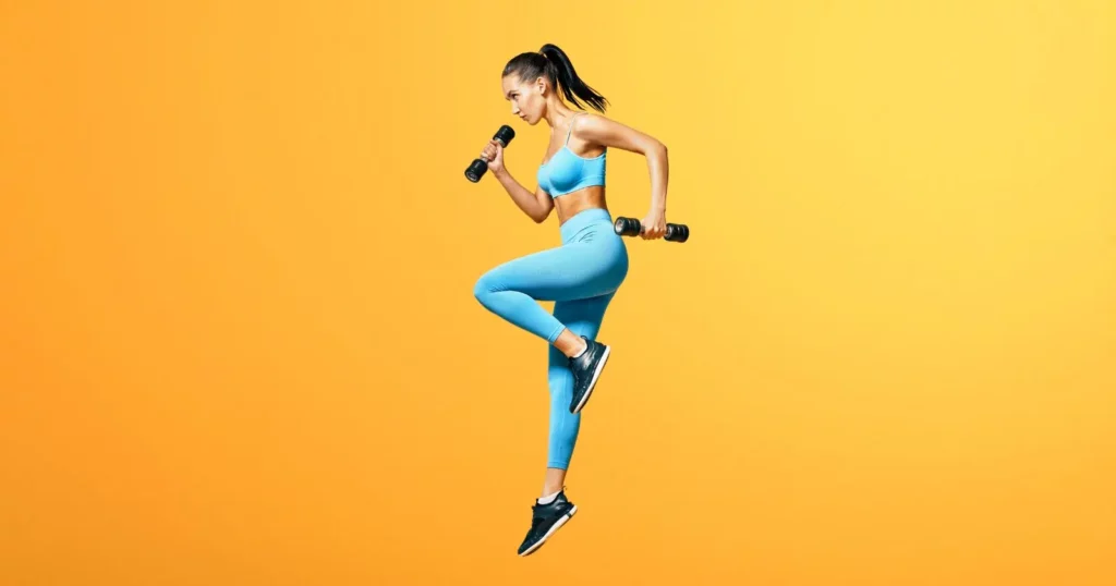carbon38 vs lululemon: woman jumping in air, wearing blue activewear bra and leggings, holding black dumbells