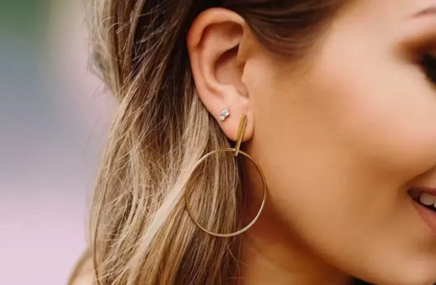side profile of woman's face, wearing gold hoop earring and crystal stud earring from Maison Miru