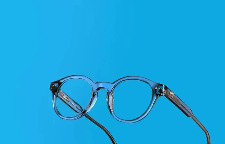 pair of black glasses over a bright blue background
