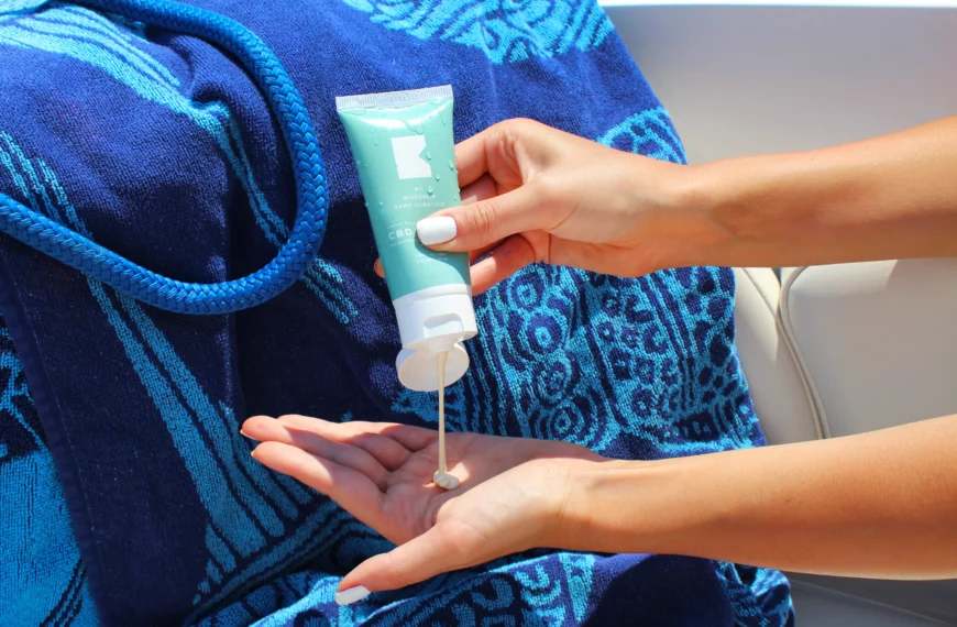 close-up on someone's hands as they are squeezing a sunscreen bottle into their left hand