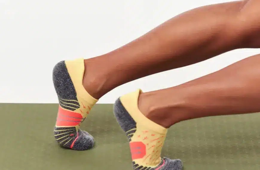 photo of a runner's feet wearing a pair of yellow socks from the brand WORN Socks